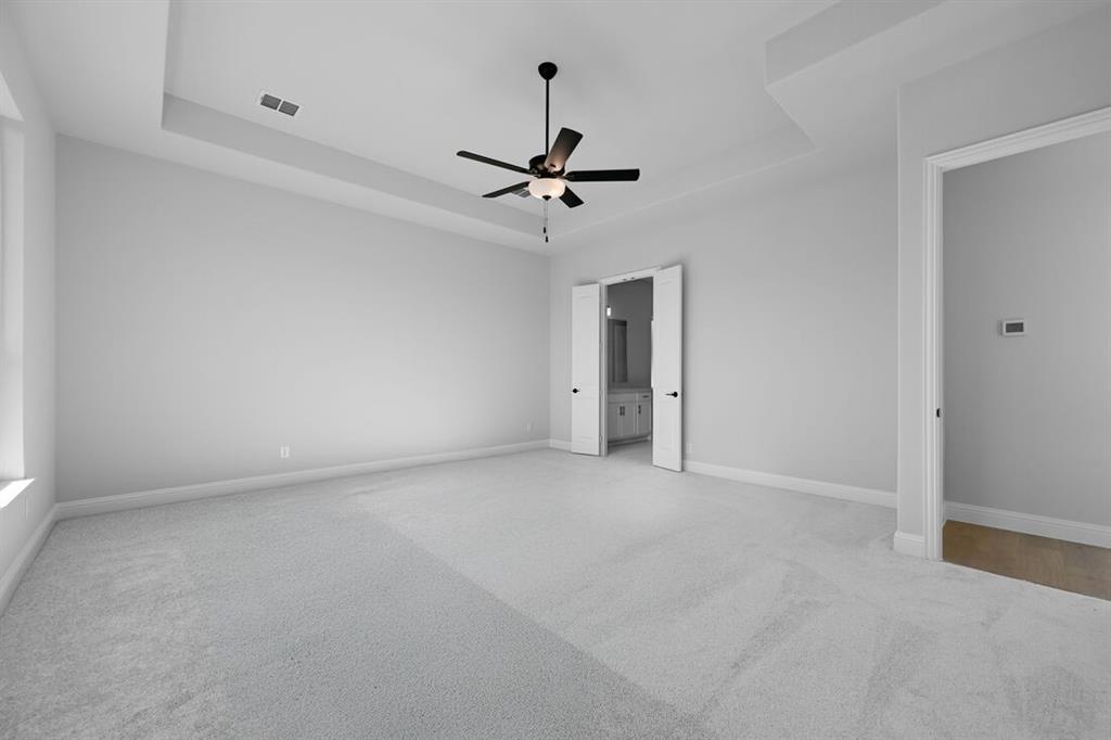1612 Yellow Rose Road Celina, TX 75009 - Photo 11 of 40 an empty room with a ceiling fan and carpet