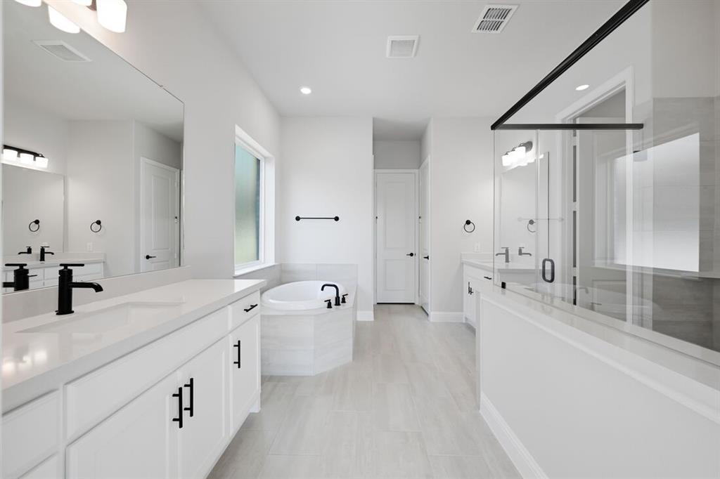 1612 Yellow Rose Road Celina, TX 75009 - Photo 12 of 40 a spacious bathroom with a tub sink and mirror