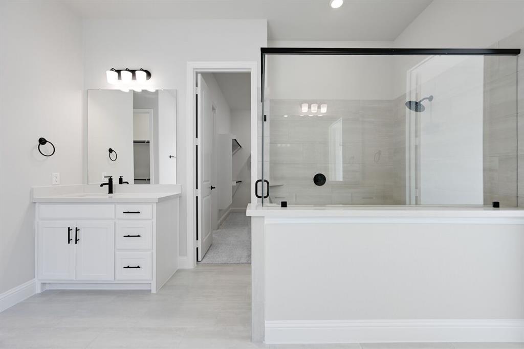1612 Yellow Rose Road Celina, TX 75009 - Photo 13 of 40 a spacious bathroom with a double vanity sink mirror double and shower