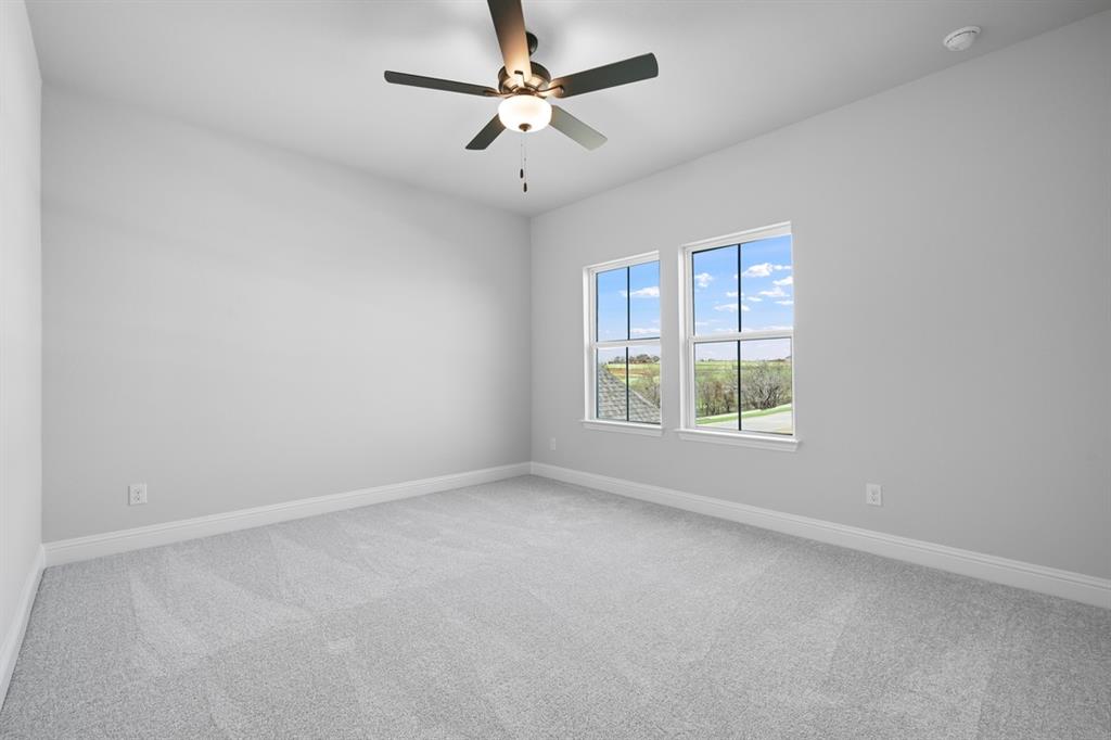 1612 Yellow Rose Road Celina, TX 75009 - Photo 18 of 40 an empty room with a window and a fan