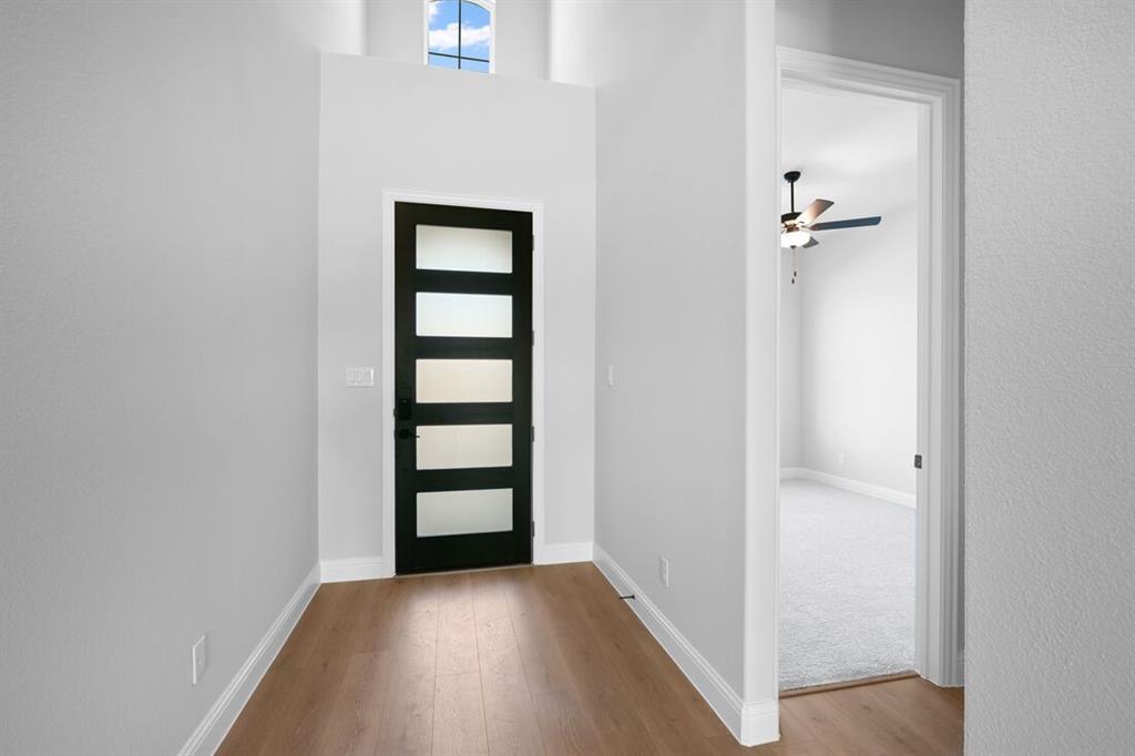 1612 Yellow Rose Road Celina, TX 75009 - Photo 32 of 40 a view of a hallway with wooden floor and closet