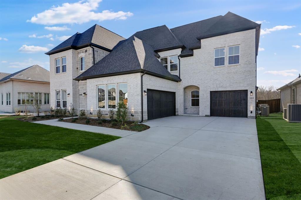 1612 Yellow Rose Road Celina, TX 75009 - Photo 35 of 40 a front view of a house with a yard and garage