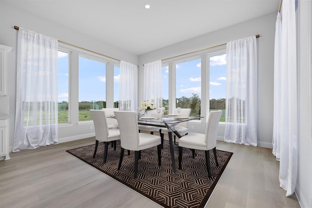 1612 Yellow Rose Road Celina, TX 75009 - Photo 8 of 40 a dining room with furniture and wooden floor