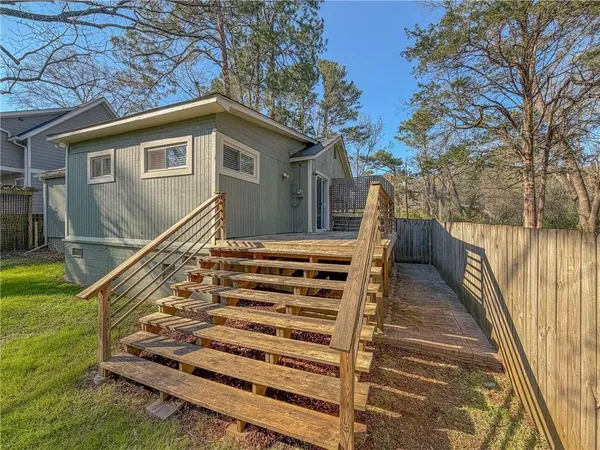 a view of a house with backyard and deck