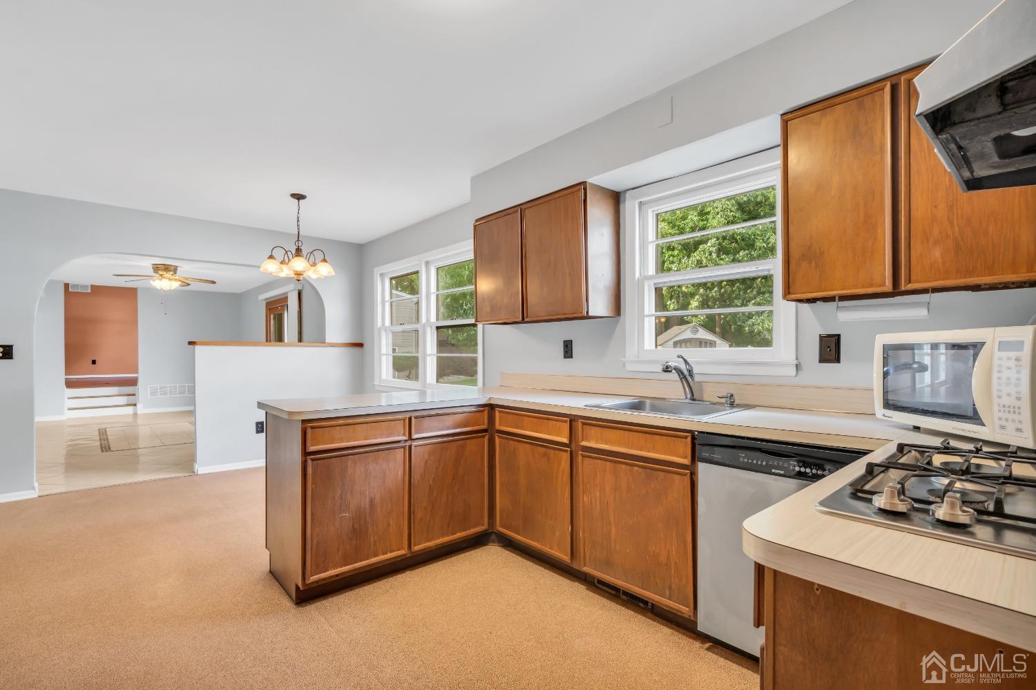 2 Greenwich Road Edison, NJ 08820 - Photo 12 of 31 a kitchen with stainless steel appliances a sink stove and cabinets