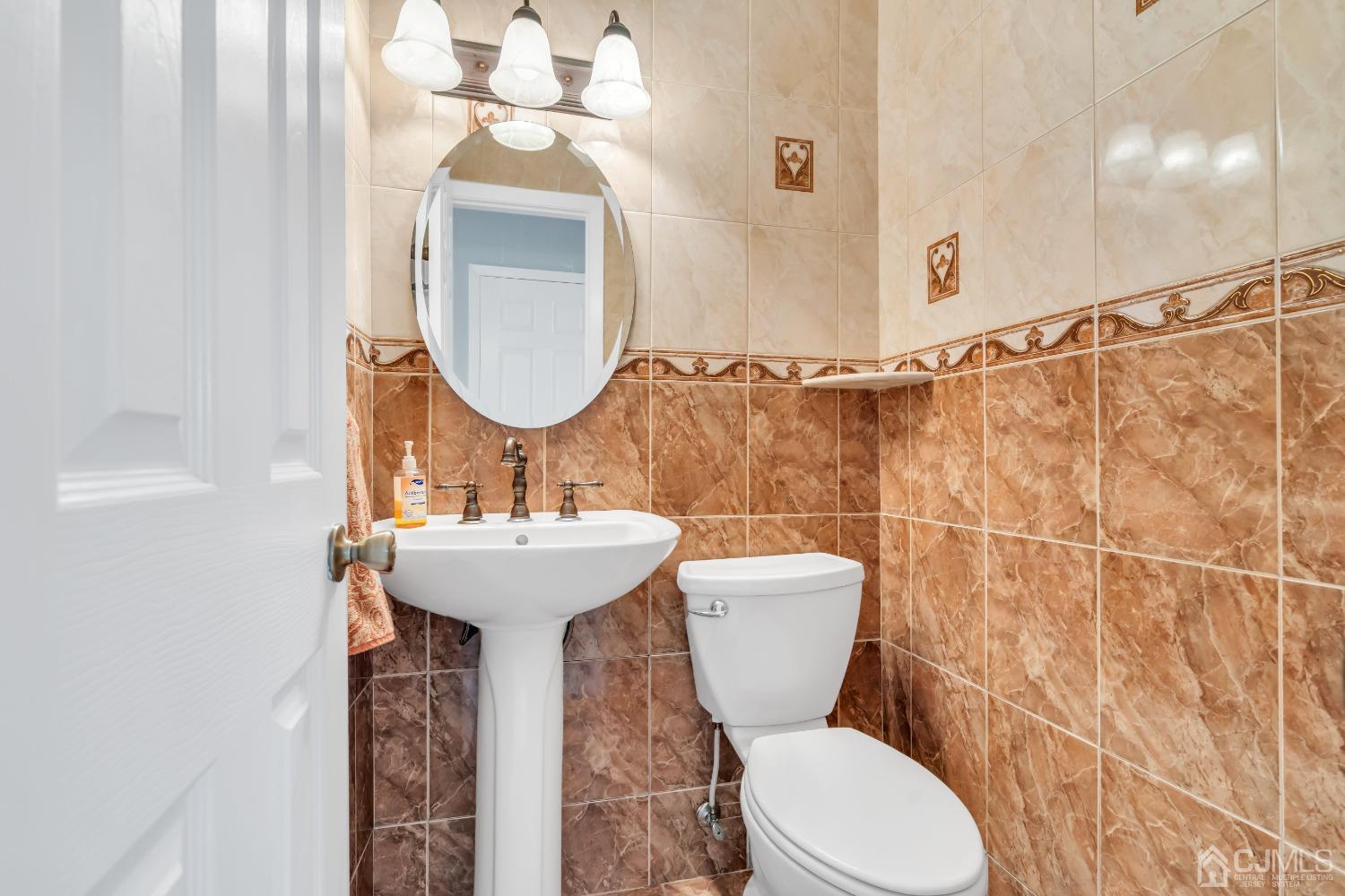 2 Greenwich Road Edison, NJ 08820 - Photo 21 of 31 a bathroom with a sink a mirror and a toilet