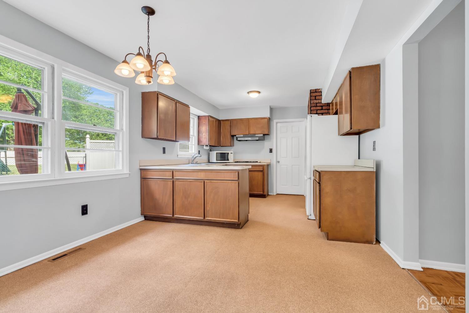 2 Greenwich Road Edison, NJ 08820 - Photo 8 of 31 a kitchen that has a lot of cabinets and wooden floor