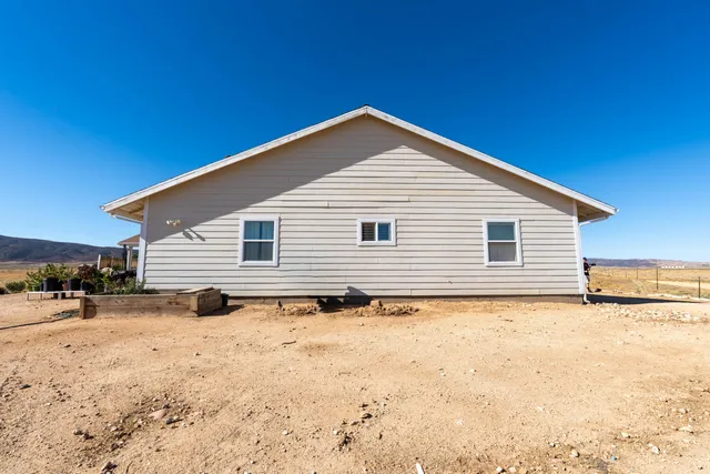 a view of a house with a yard covered in snow