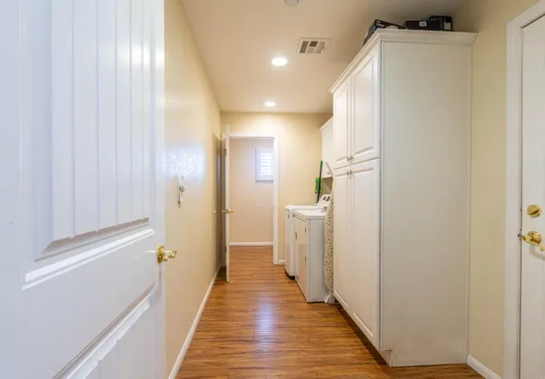 a view of a hallway with wooden floor