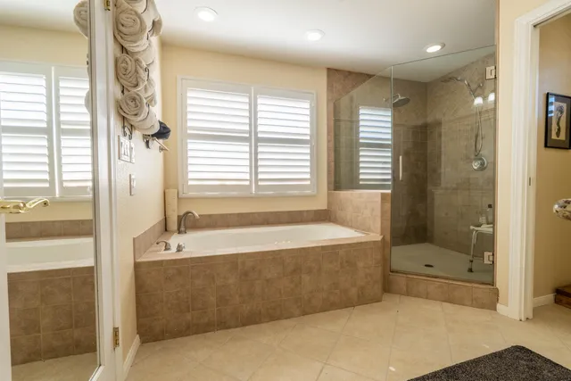 a bathroom with a tub shower and sink