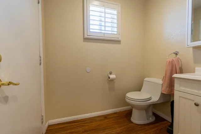 a bathroom with a toilet and a window
