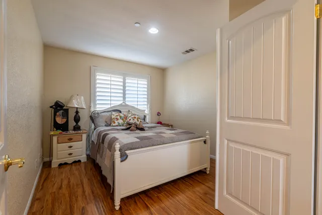 a bed sitting in a bedroom next to a window