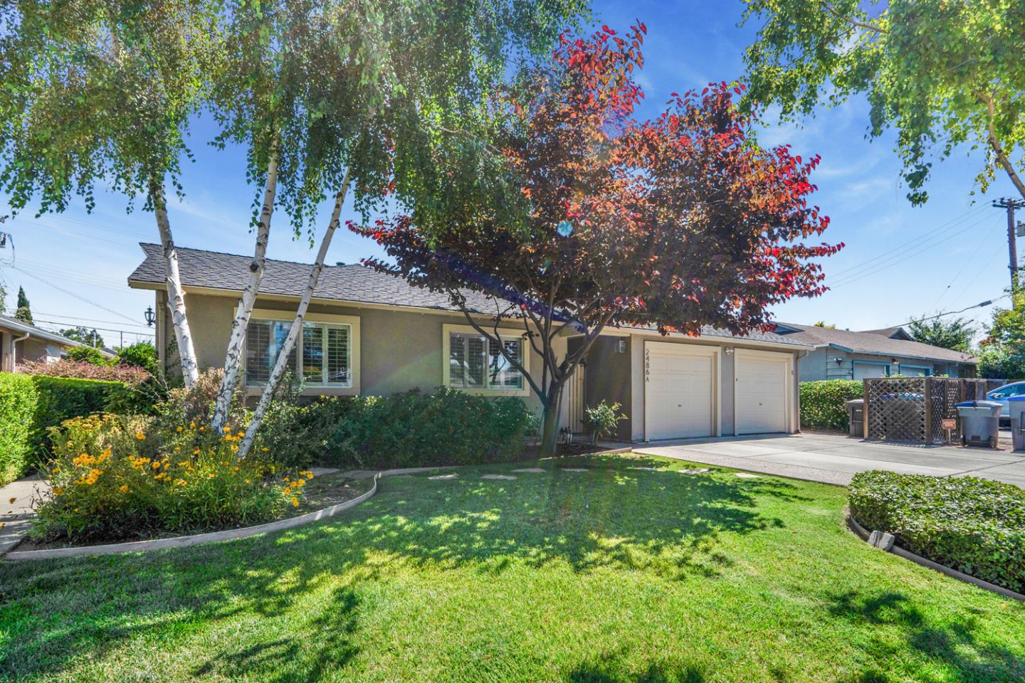 a front view of a house with garden