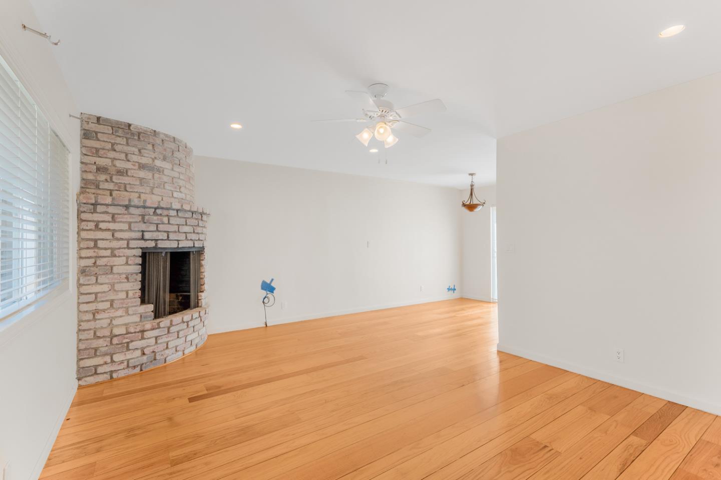 2486 Whitney Drive Mountain View, CA 94043 - Photo 31 of 43 a view of an empty room with wooden floor and a fireplace