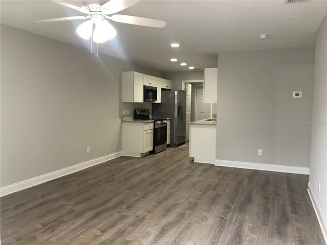 a view of a kitchen with a sink and a refrigerator