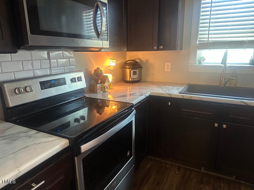 150 Cornerstone Lane Timberlake, NC 27583 - Photo 22 of 38 a kitchen with a sink stove and cabinets