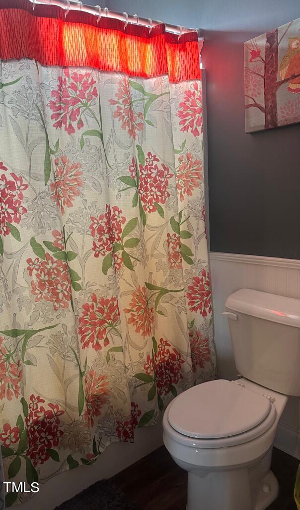 150 Cornerstone Lane Timberlake, NC 27583 - Photo 27 of 38 a white toilet sitting next to a shower curtain