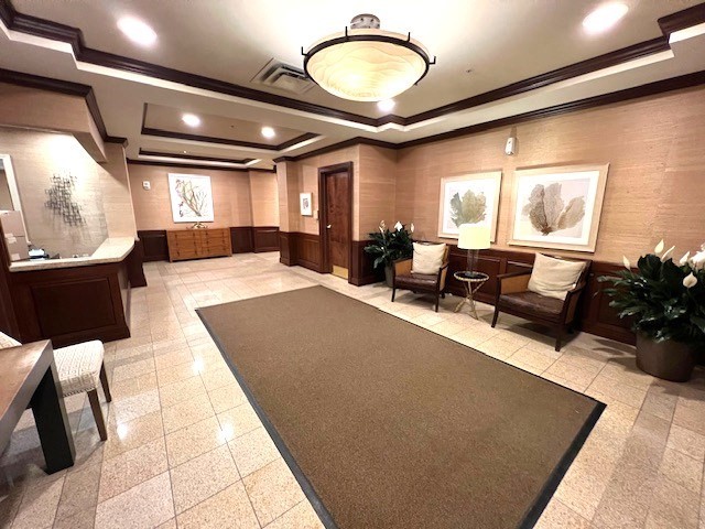 1 Nassau Street, Unit 1607 Boston, MA 02111 - Photo 12 of 17 a living room with furniture a large window and a chandelier