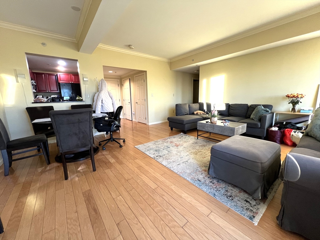 1 Nassau Street, Unit 1607 Boston, MA 02111 - Photo 3 of 17 a living room with furniture and a fireplace