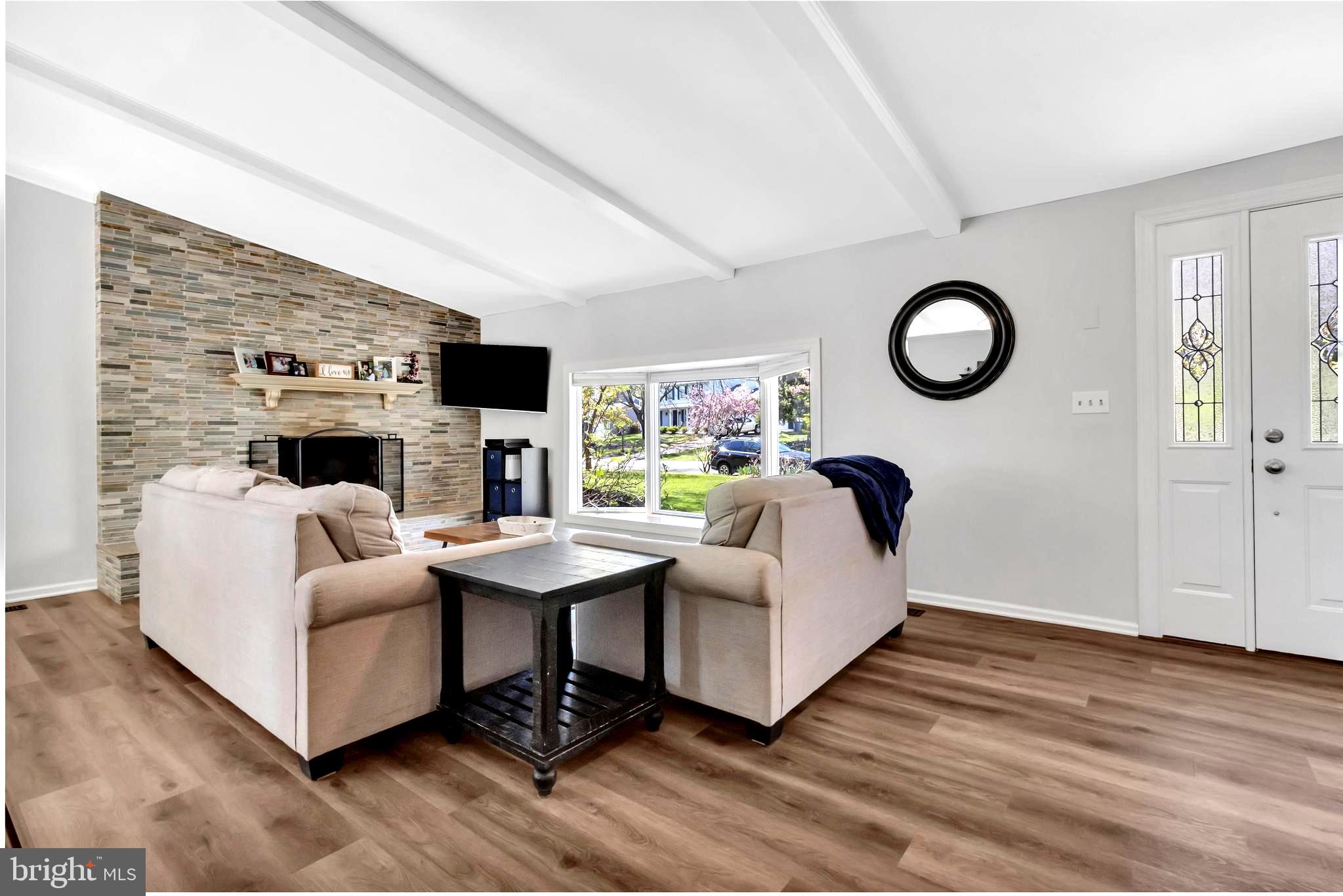 607 Bay Green Drive Arnold, MD 21012 - Photo 12 of 52 a living room with furniture a fireplace and a flat screen tv
