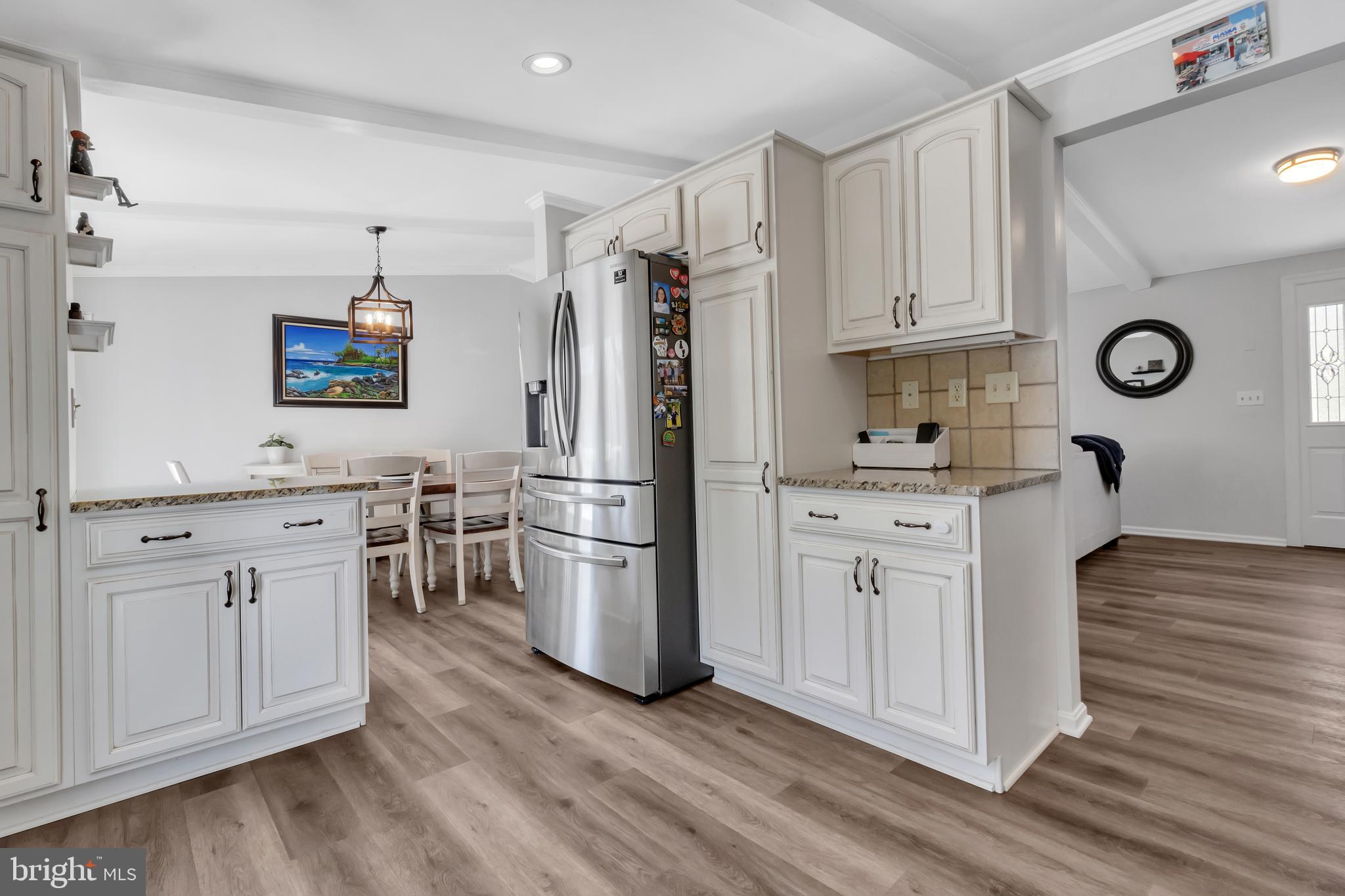 607 Bay Green Drive Arnold, MD 21012 - Photo 18 of 52 a kitchen with white cabinets and stainless steel appliances