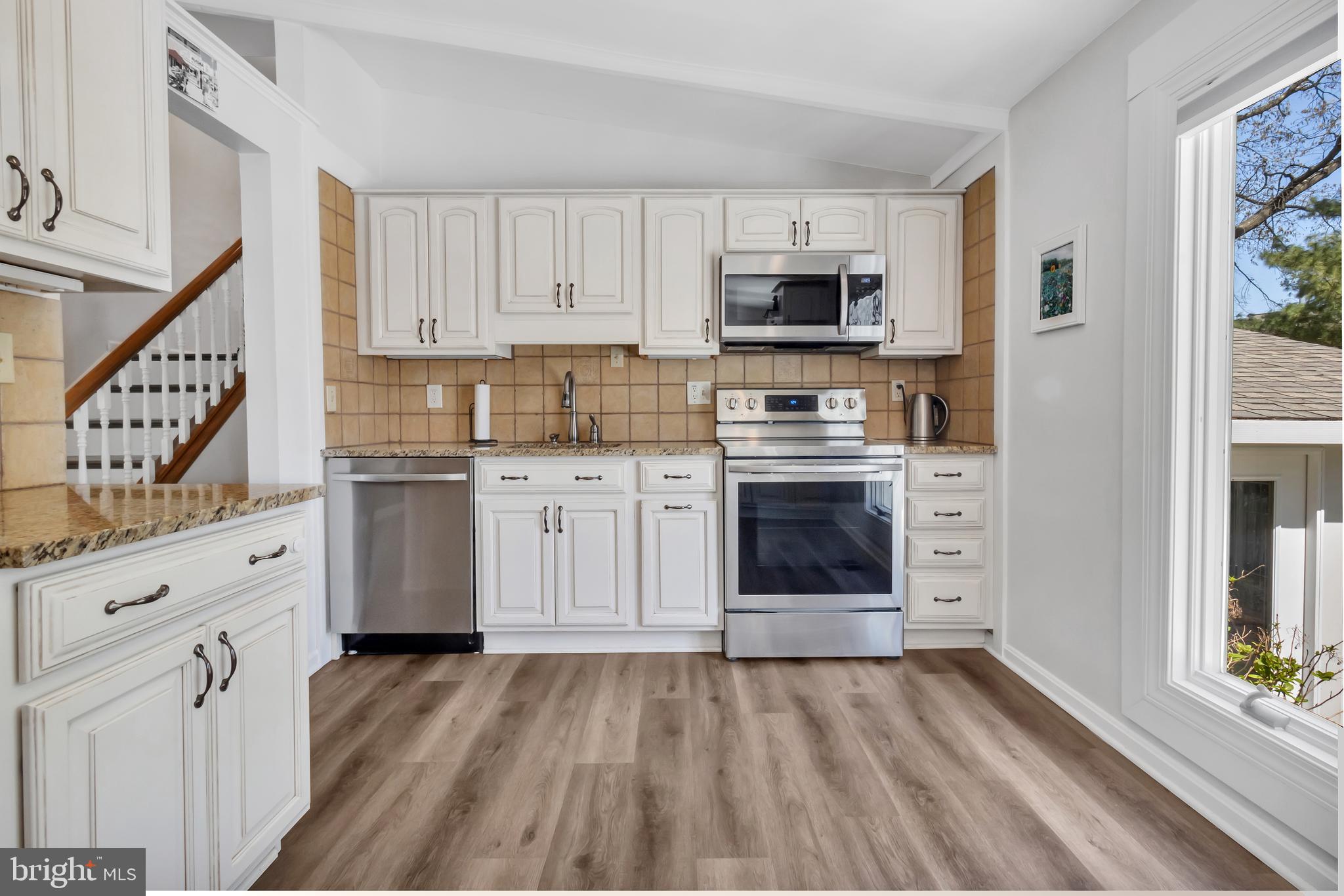 607 Bay Green Drive Arnold, MD 21012 - Photo 20 of 52 a kitchen with stainless steel appliances a stove top oven a sink and a refrigerator