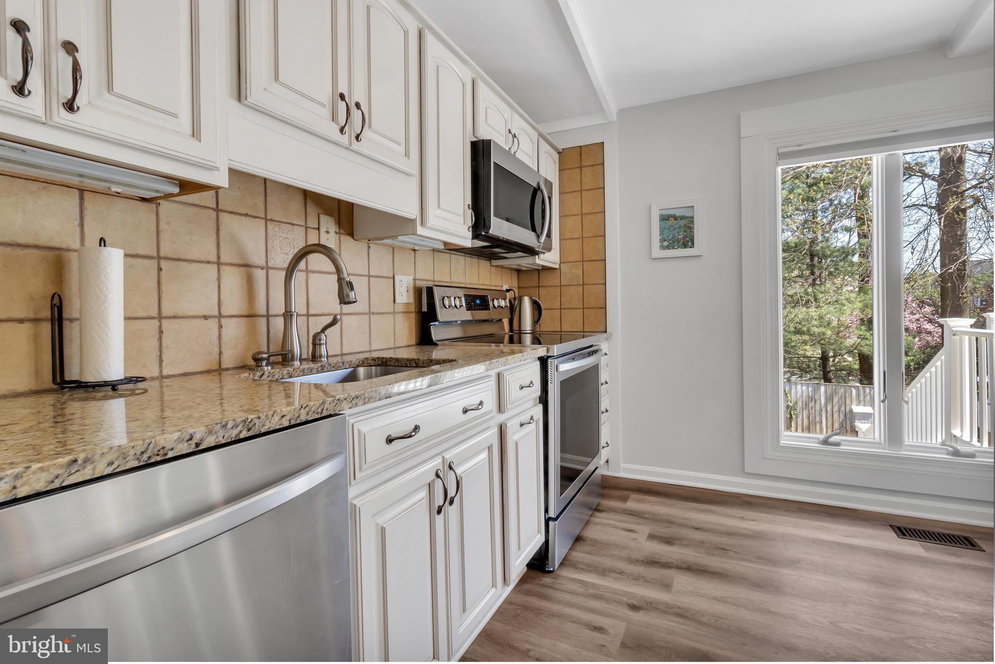 607 Bay Green Drive Arnold, MD 21012 - Photo 23 of 52 a kitchen with stainless steel appliances granite countertop a sink and a stove