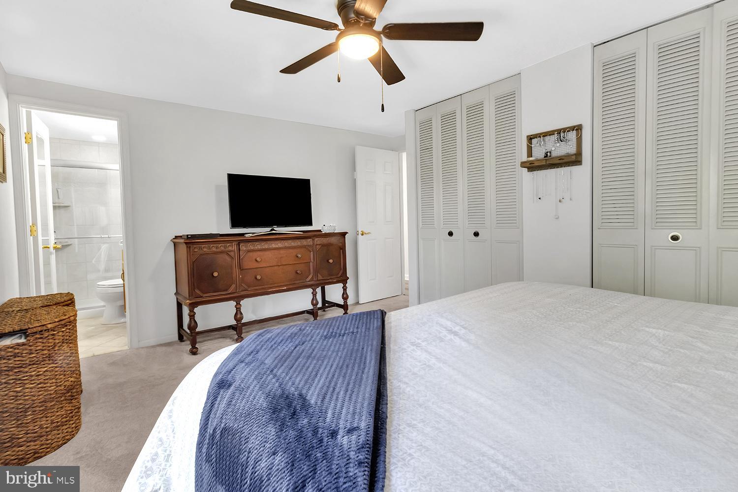 607 Bay Green Drive Arnold, MD 21012 - Photo 29 of 52 a spacious bedroom with a bed and a flat screen tv