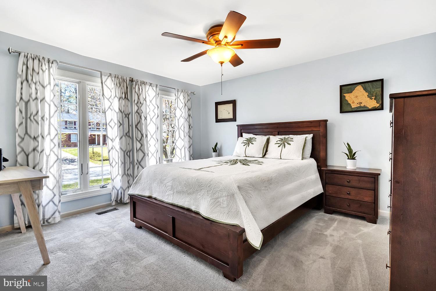 607 Bay Green Drive Arnold, MD 21012 - Photo 31 of 52 a spacious bedroom with a bed and a chandelier