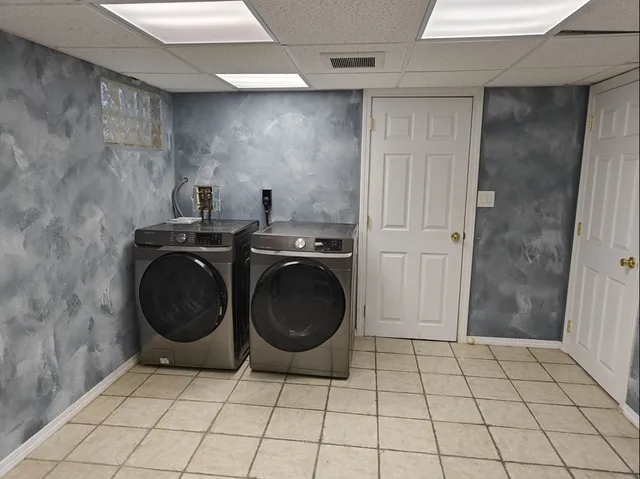 a view of a storage and utility room with washer and dryer