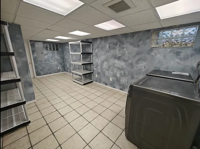 a view of an empty room with wooden floor and a sink