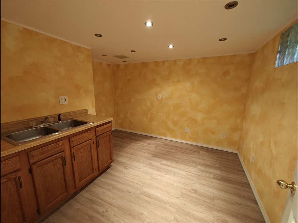 548 Worcester Street Natick, MA 01760 - Photo 13 of 21 a view of an empty room with wooden floor and a sink