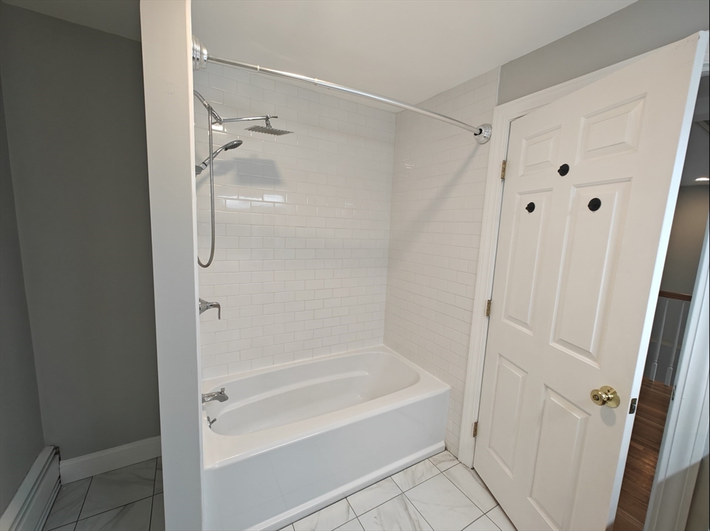 548 Worcester Street Natick, MA 01760 - Photo 15 of 21 a bathroom with a bathtub