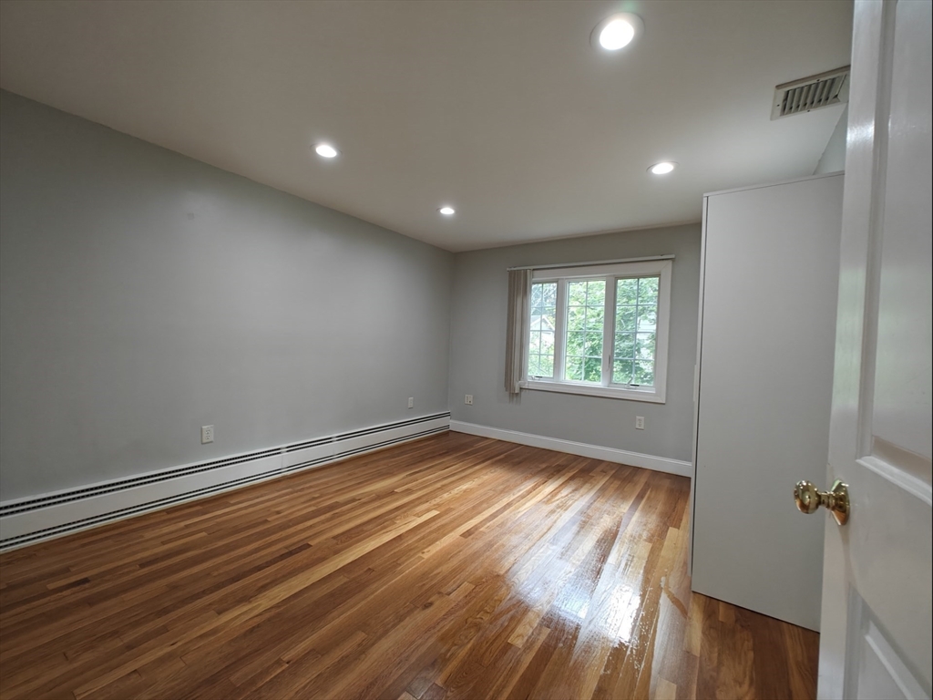 548 Worcester Street Natick, MA 01760 - Photo 16 of 21 an empty room with wooden floor and windows