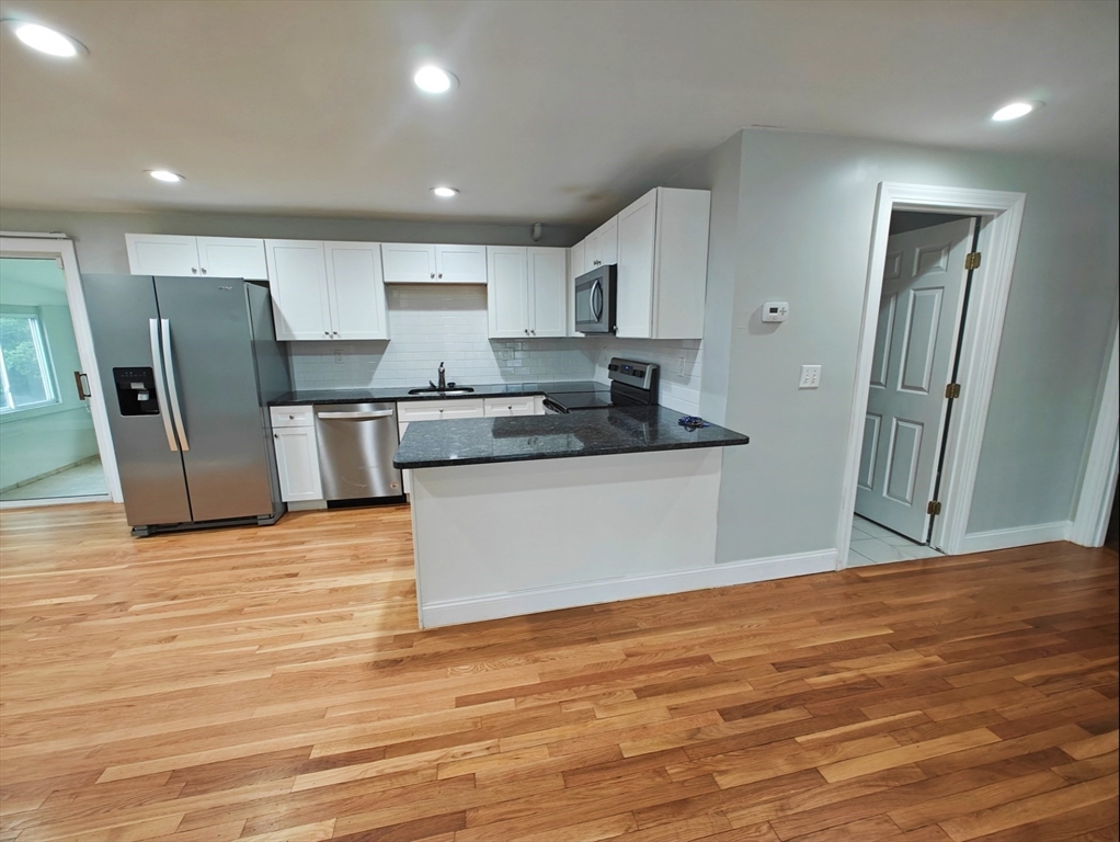 548 Worcester Street Natick, MA 01760 - Photo 2 of 21 a kitchen with stainless steel appliances granite countertop a refrigerator sink and stove