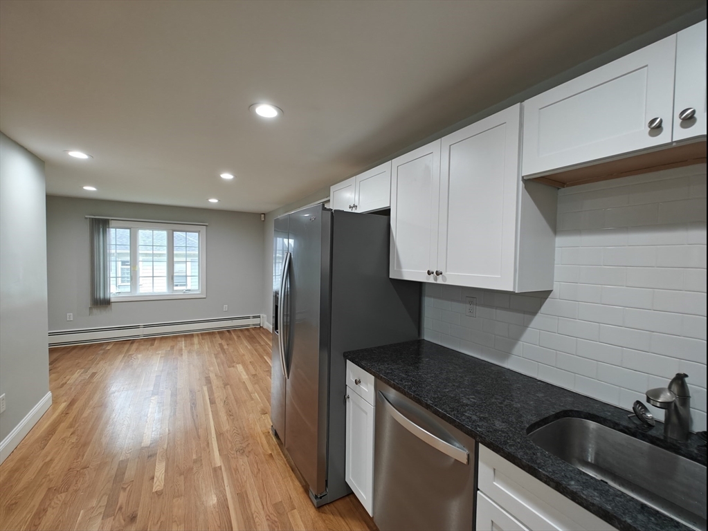 548 Worcester Street Natick, MA 01760 - Photo 4 of 21 a kitchen with granite countertop stainless steel appliances sink stove refrigerator and cabinets