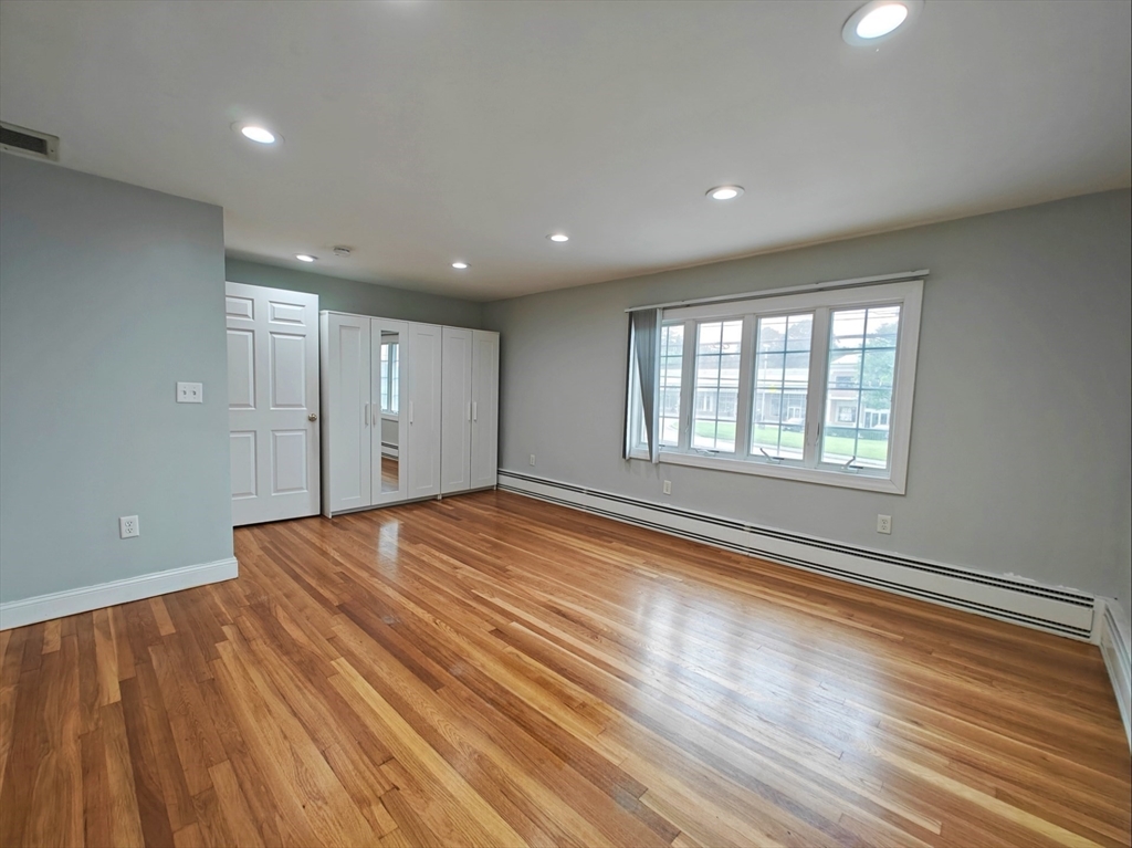 548 Worcester Street Natick, MA 01760 - Photo 5 of 21 a view of empty room with wooden floor and fan