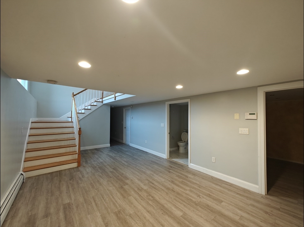 548 Worcester Street Natick, MA 01760 - Photo 8 of 21 an empty room with wooden floor and windows