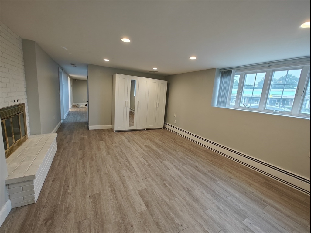 548 Worcester Street Natick, MA 01760 - Photo 10 of 21 a view of an empty room with wooden floor and a window