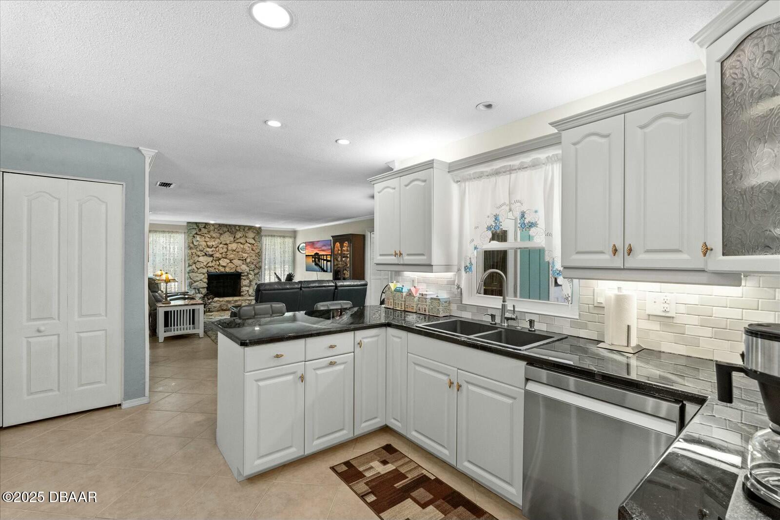 1 Cobblestone Trail Ormond Beach, FL 32174 - Photo 17 of 31 a kitchen with stainless steel appliances granite countertop a sink and cabinets