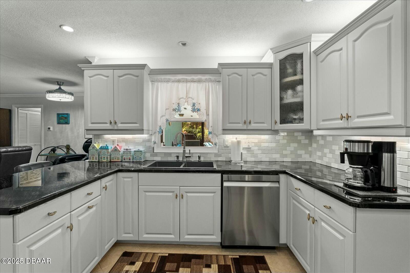 1 Cobblestone Trail Ormond Beach, FL 32174 - Photo 18 of 31 a kitchen with stainless steel appliances granite countertop a sink stove and cabinets