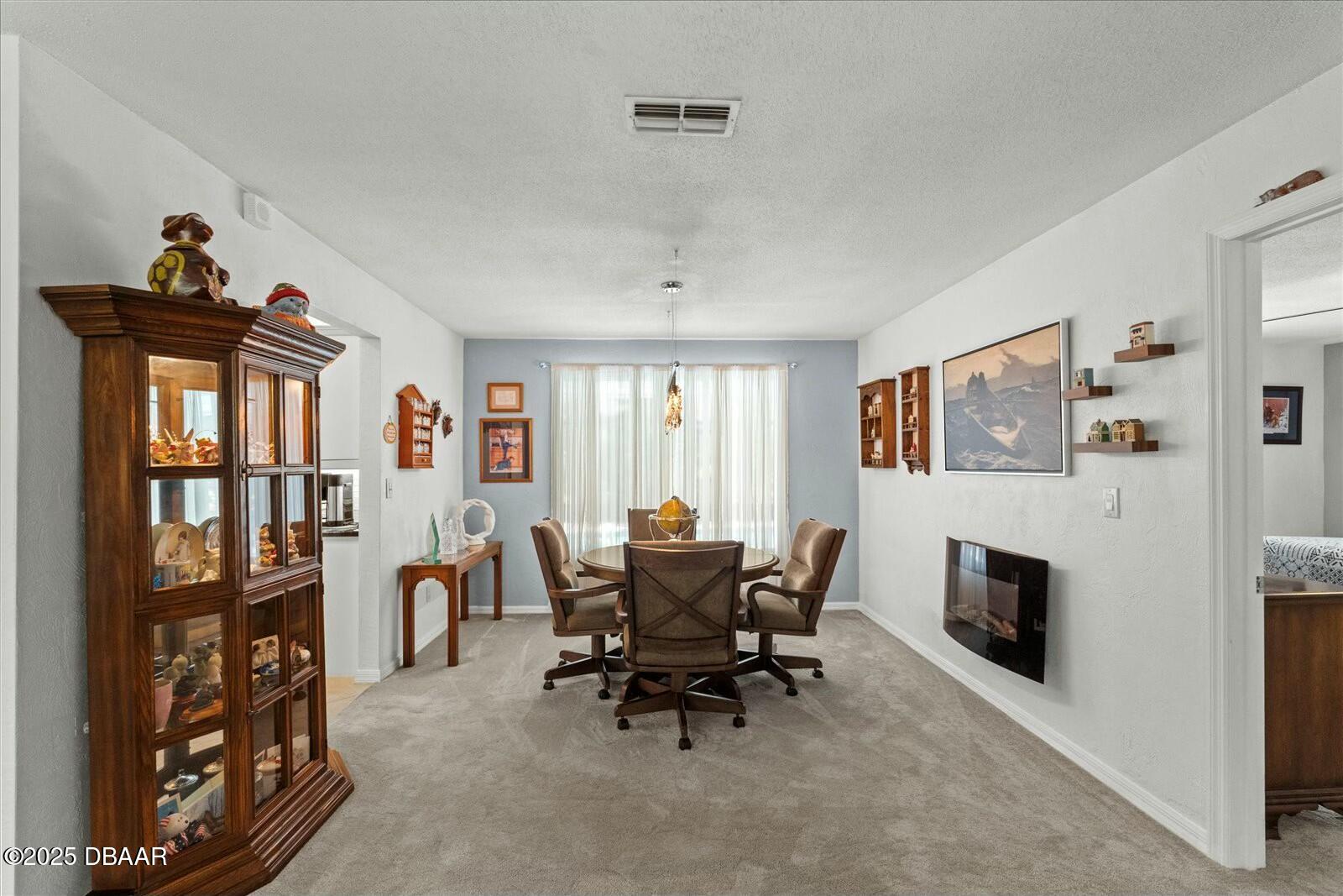 1 Cobblestone Trail Ormond Beach, FL 32174 - Photo 19 of 31 a dining room with furniture and a fireplace