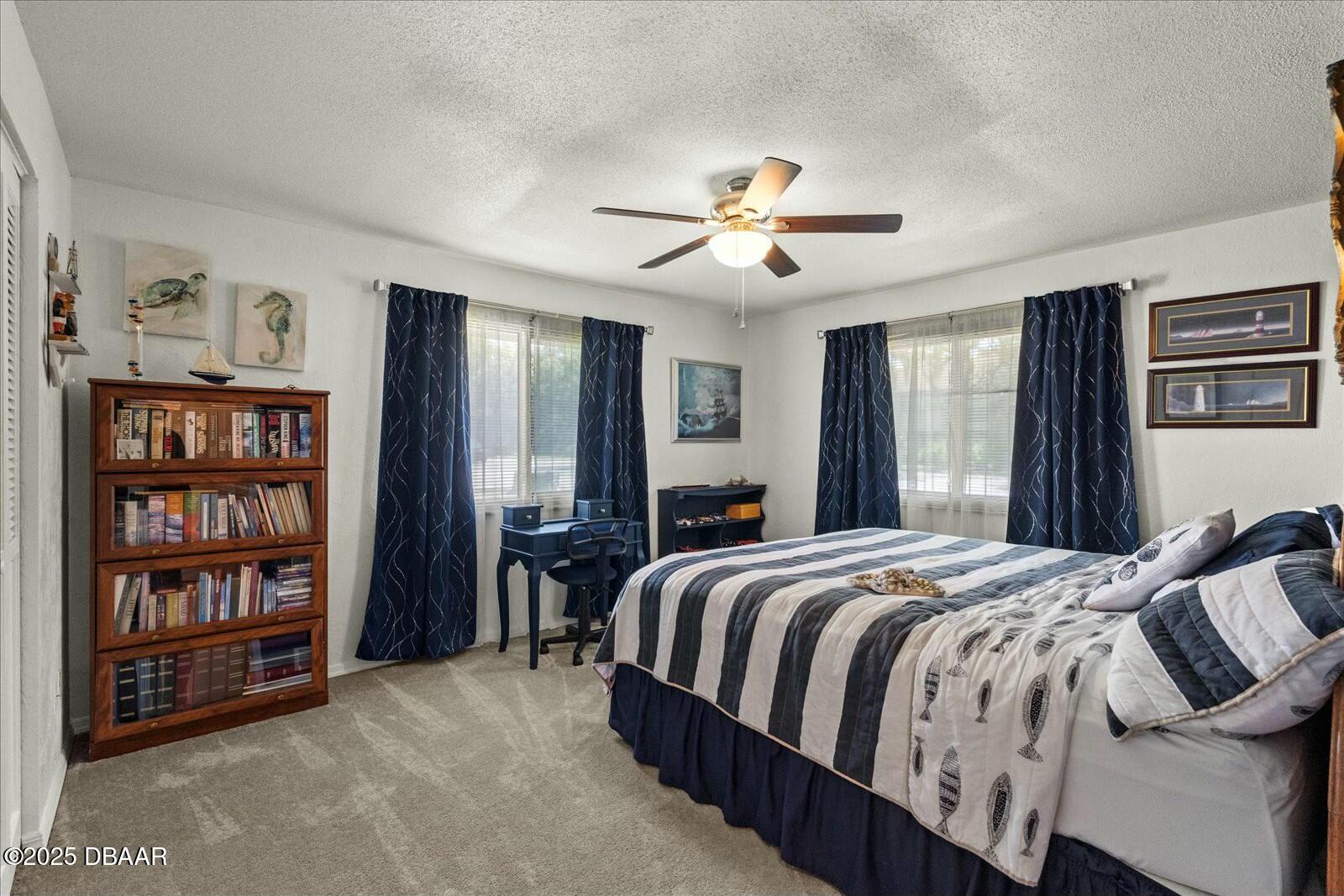 1 Cobblestone Trail Ormond Beach, FL 32174 - Photo 24 of 31 a bedroom with a large bed and a chandelier