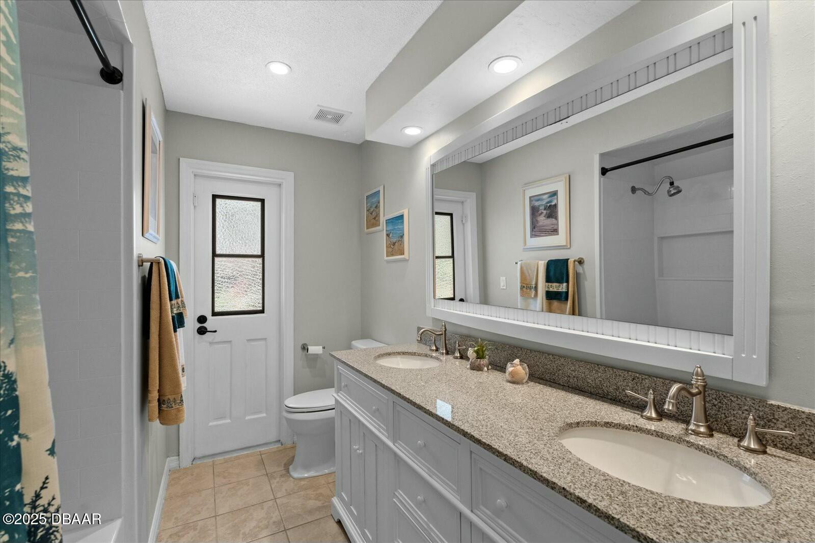 1 Cobblestone Trail Ormond Beach, FL 32174 - Photo 26 of 31 a bathroom with a granite countertop sink toilet and shower