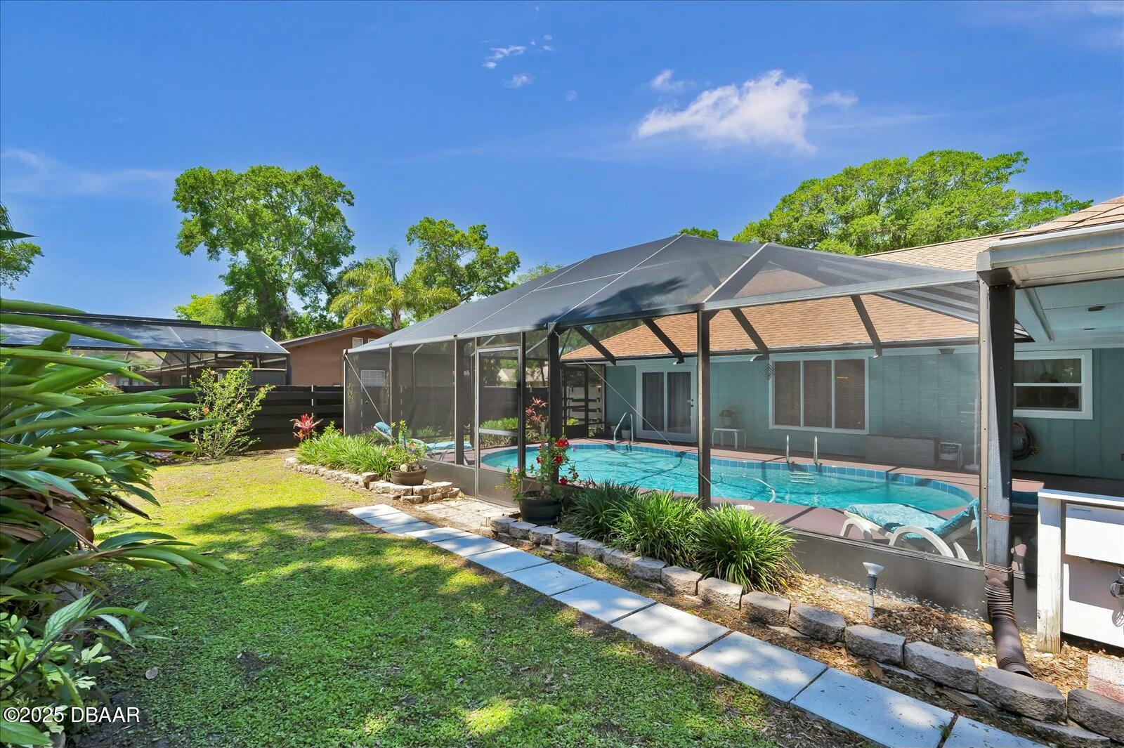 1 Cobblestone Trail Ormond Beach, FL 32174 - Photo 30 of 31 a backyard of a house with a garden and outdoor seating