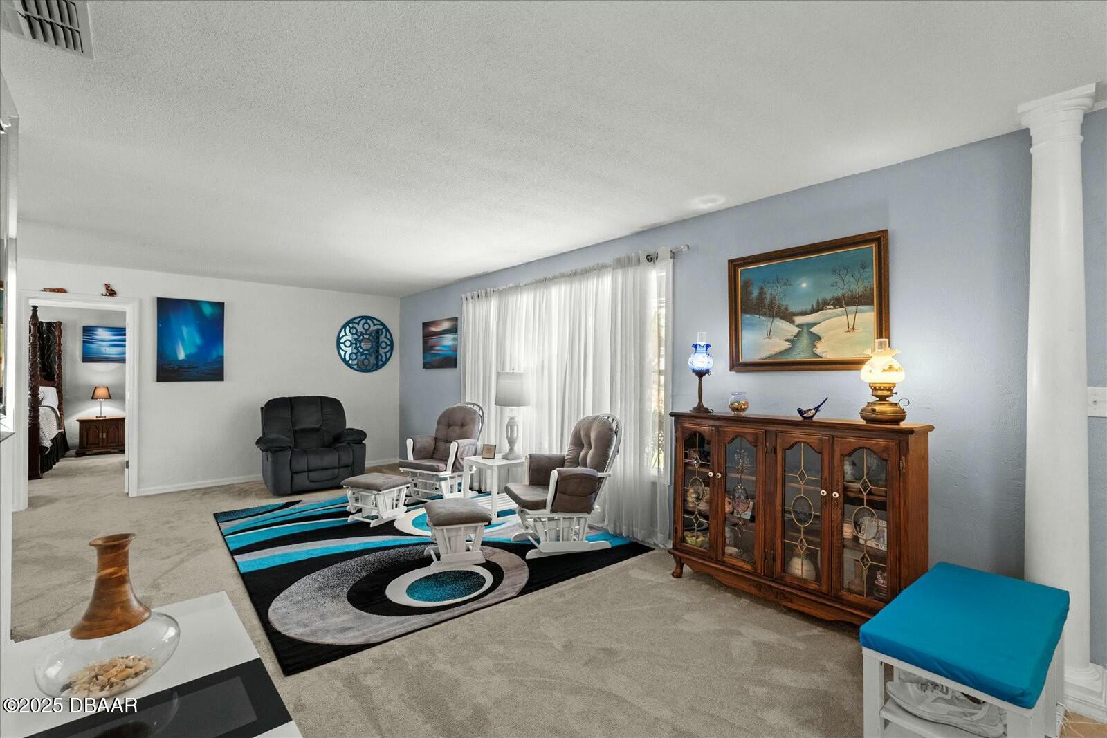 1 Cobblestone Trail Ormond Beach, FL 32174 - Photo 7 of 31 a living room with furniture and a flat screen tv