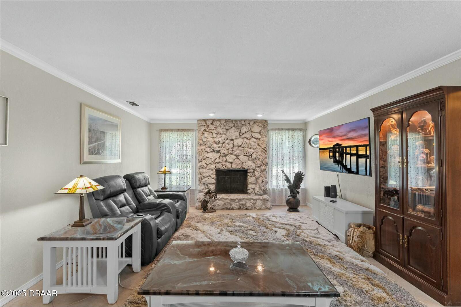 1 Cobblestone Trail Ormond Beach, FL 32174 - Photo 10 of 31 a living room with furniture a fireplace and a flat screen tv
