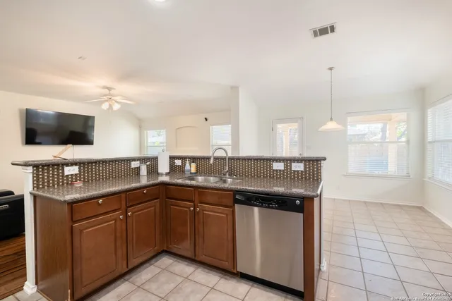 a kitchen with a sink and cabinets