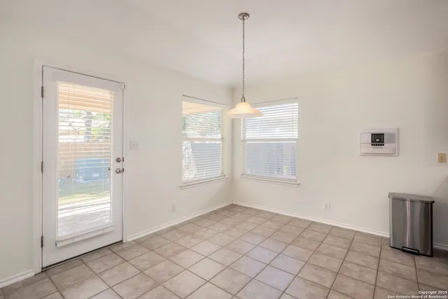 a view of an empty room with windows