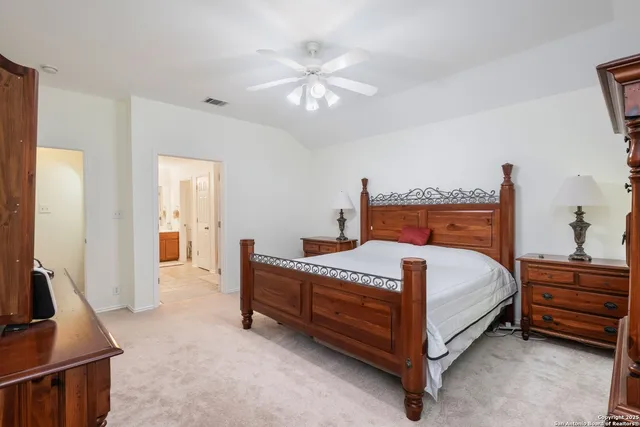a bedroom with a bed and a flat tv screen on dresser